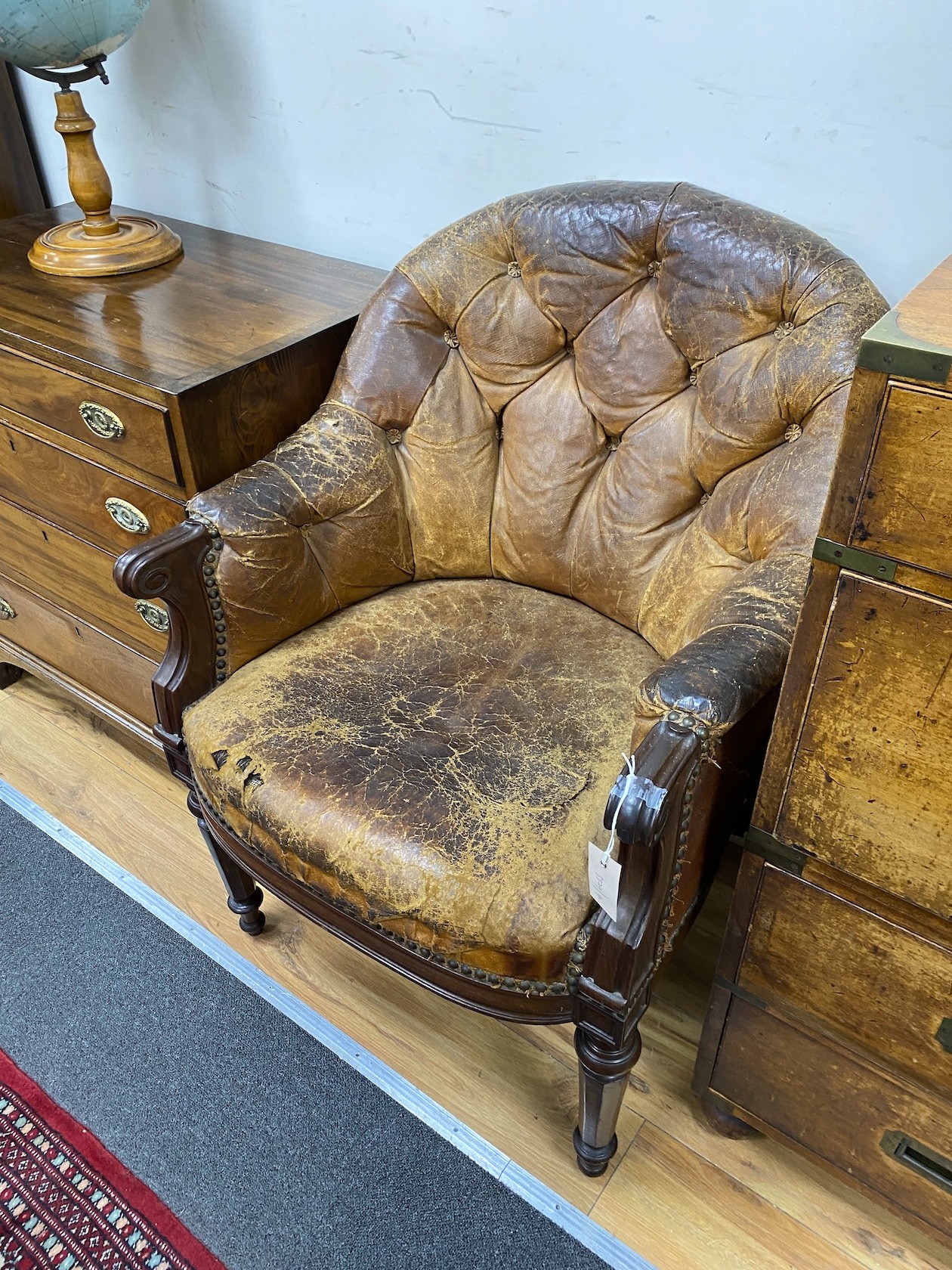 An early Victorian buttoned brown leather mahogany library chair, width 65cm, depth 62cm, height 86cm